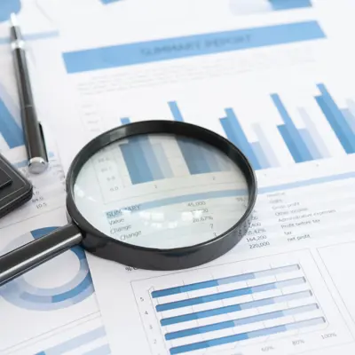 Image of Magnifying Glass and Calculator on Financial Statements