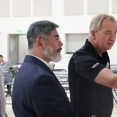 Image of officials helping woman at Open House