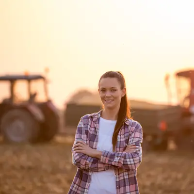 Woman in front of Farm Equipment