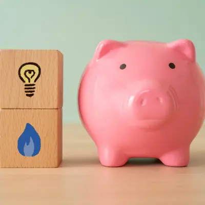 Image of Piggy Bank next to Blocks with Gas and Electricity icons on